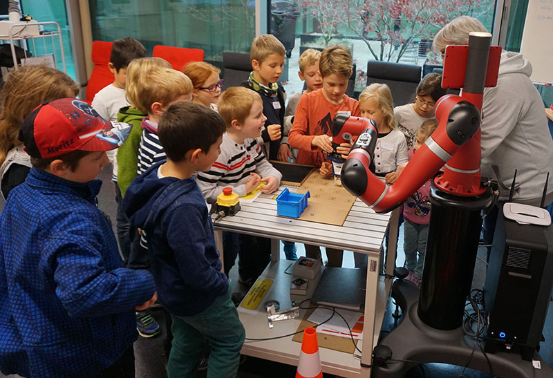 Kinder steuern einen Roboter